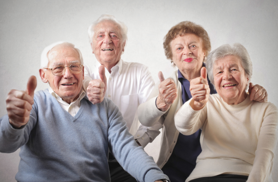 Happy seniors giving thumbs up